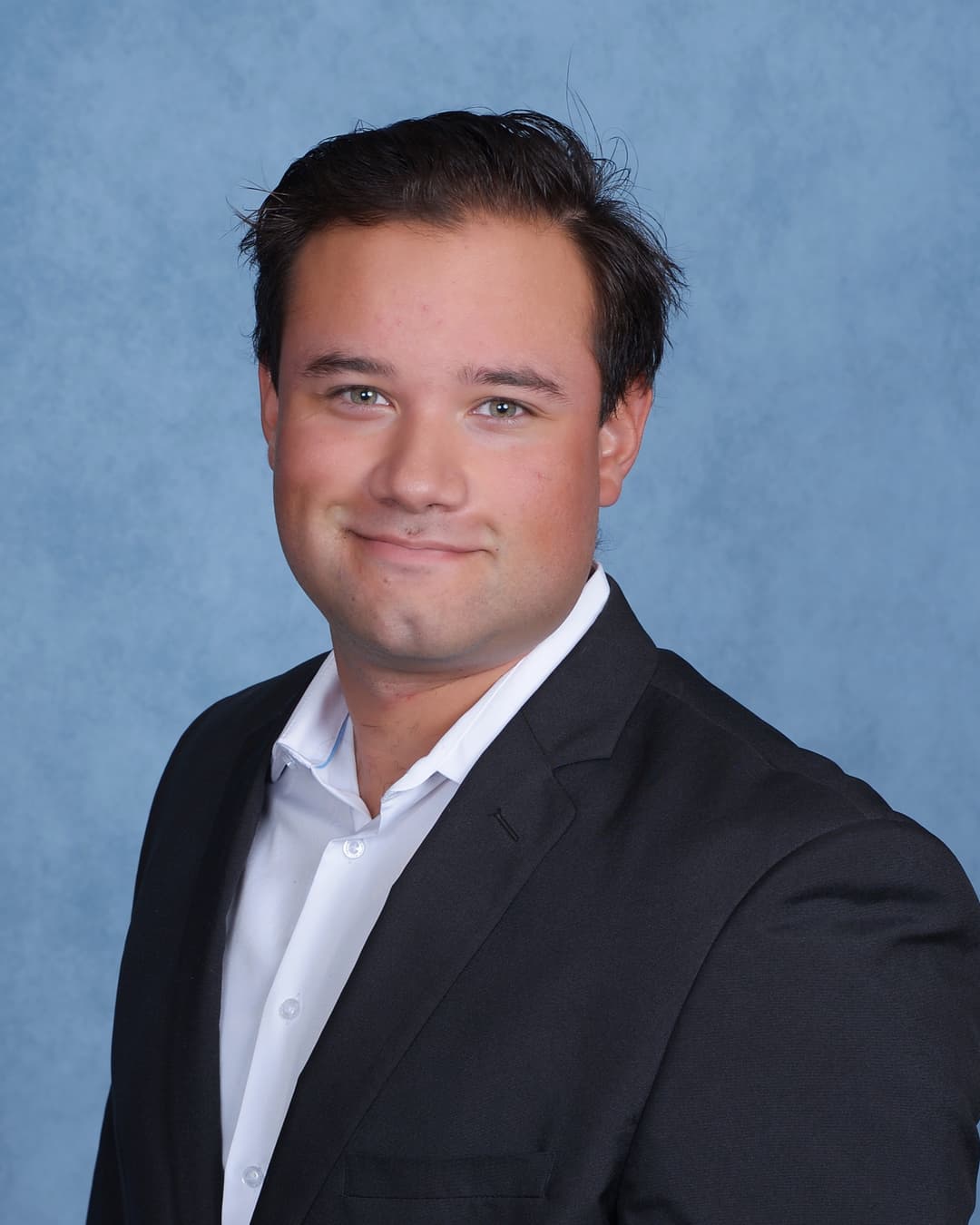 Ryan Torrez headshot blue